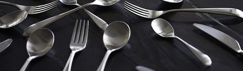 fork spoons knives background / beautiful serving tableware