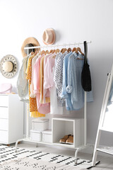 Rack with stylish women's clothes indoors. Interior design
