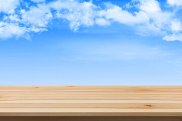 Wooden board empty table in front of sky background.