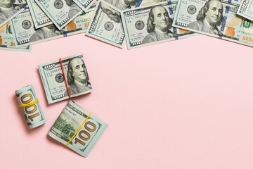 Heap of hundred Dollar Bills on colored background top view, with empty place for your text business money concept