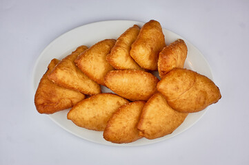 golden pies with potatoes on a white background