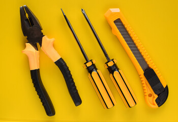 Layout of carpentry tools on a yellow background. Set of hand building tools. Equipment for the repairman.