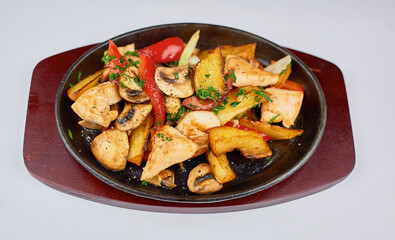 hot frying pan on a stand on a white background