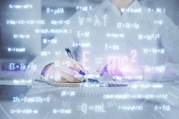 Science formula hologram over woman's hands taking notes background. Concept of study. Double exposure