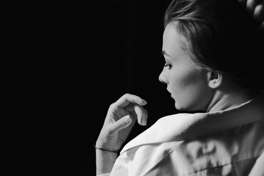 Black and white portrait of beautiful dancing caucasian girl with dramatical emotion on the stage.Retro fashion. Black and white image.