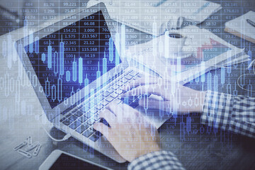Double exposure of forex graph with man working on computer on background. Concept of market analysis.