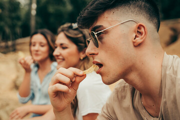 Young people eating potato chips