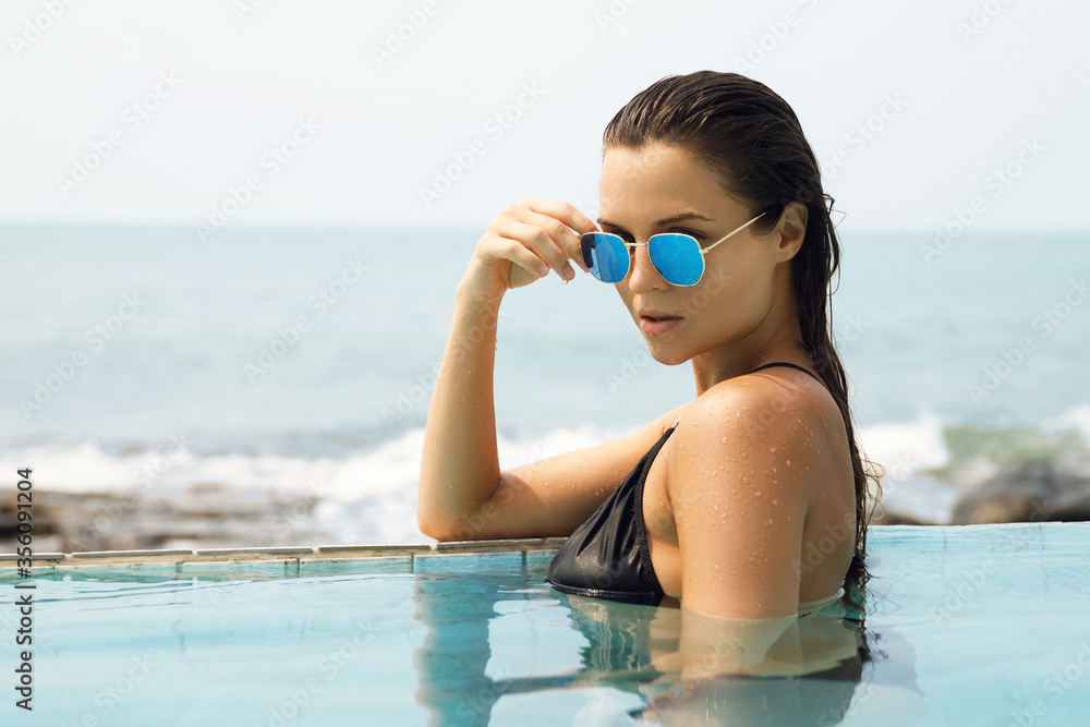 Wall mural sexy woman relaxing in the pool