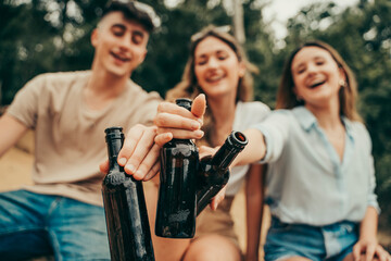 Young people drinking beer in nature.