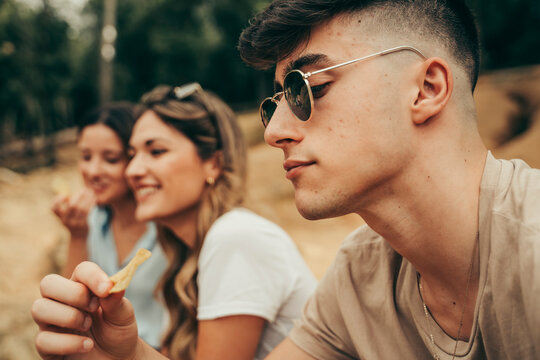 Young People Eating Potato Chips.