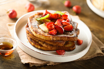 Strawberry French toast with maple syrup and butter