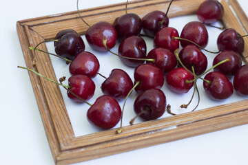 cherry in a wooden frame on a white background
