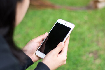Close up female hands holding smart phone black screen for copy space.
