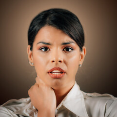 Emotion Fear. Face of a beautiful fearful young woman, expressing fear, studio portrait, brown background