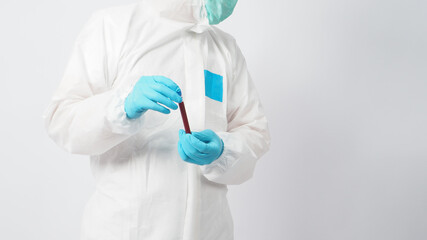 Male with PPE suite and Hand wearing doctor glove is holding blood collection tube on white background.