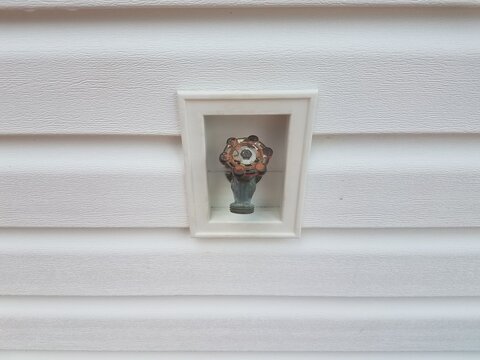 Outdoor Water Spigot And White Siding