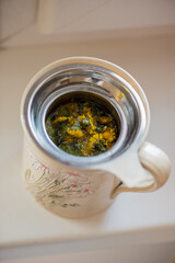 DIY concept. Ceramic handmade decorative cup with hot herbal tea..