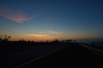 A sunset over a highway