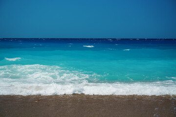 Peaceful sea wave foams on the beach, Aegean Sea, Rhodes, Greece.