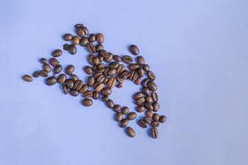 Fresh coffee beans on the purple table background. 