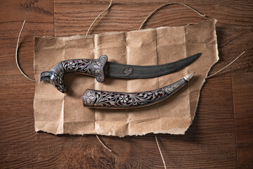 old knife Damascus steel on paper and wood 