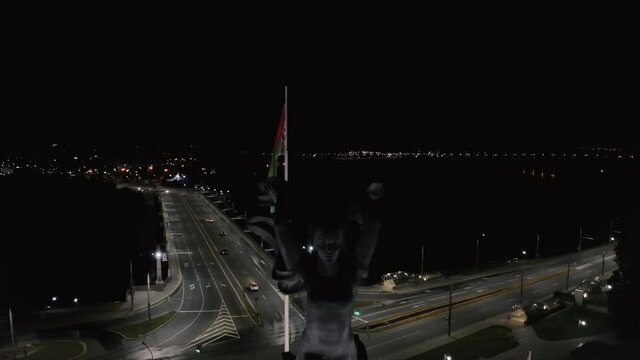 large flag of Belarus and the city at night