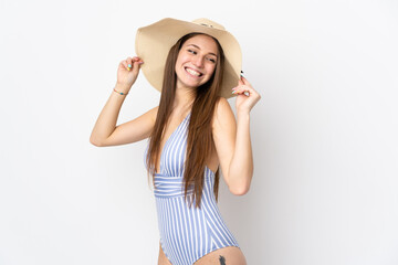 Obraz na płótnie Canvas Young caucasian woman isolated on white background happy in swimsuit in summer holidays