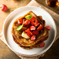 Strawberry French toast with maple syrup and butter