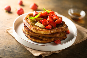 Strawberry French toast with maple syrup and butter