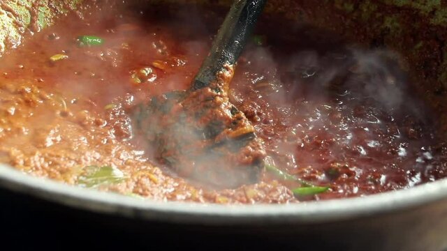 Close up of boiling hot Beef Kala Bhuna in wok outdoors