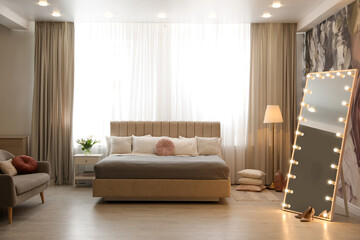 Beautiful room interior with large bed and mirror