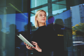 Portrait of beautiful young female holding mobile phone in hands 