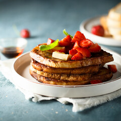 Strawberry French toast with maple syrup and butter