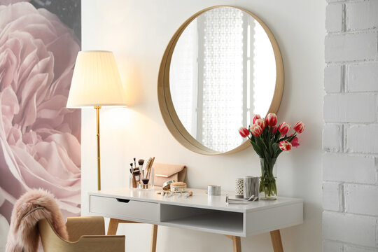 Stylish room interior with dressing table and mirror