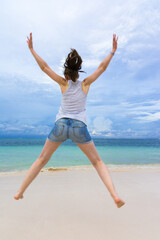 Fototapeta premium Young woman enjoying life on a caribbean beach, Bavaro Beach, Punta Cana, Dominican Republic