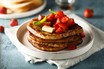 Strawberry French toast with maple syrup and butter