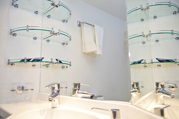 Clean and minimalistic modern design bathroom with sink, shower, toilet and mirror in cabin or...
