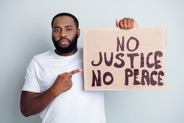 No justice no peace. Photo of disappointed dark skin african protester direct finger placard...