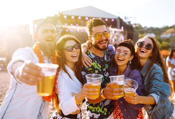 Group of friends with beer dancing and having fun at music festival together. Summer Beach party,...