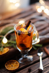 Cup of tea with ginger and cinnamon on wooden background