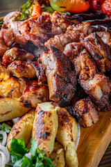 Assorted Mixed different grilled meat with vegetables on table