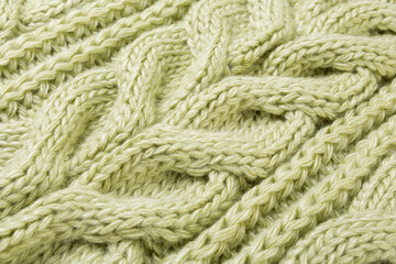 large pattern of woolen knitted fabric, green color, selective focus