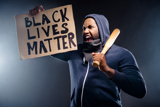 Profile Side Photo Of Furious Afro American Guy Feel Dissatisfaction African Community Injustice Hold Banner Baseball Beat Yell Shout Isolated Over Black Color Background