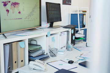 Fototapeta na wymiar Horizontal background image of messy desk at empty workplace in busy clinic, copy space