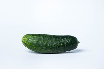 Green cucumber on a white background. Harvest from the garden. Ingredient for making salad.
