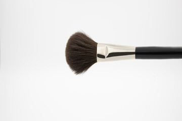 black fluffy brush for makeup artist on a white background