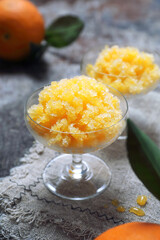 Orange granita, frozen summer dessert and  freshe orange fruits, selective focus