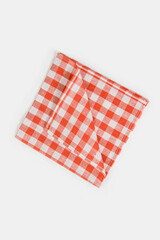 Folded checkered napkin lies on a white background