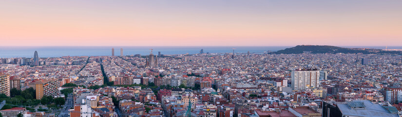 Fototapeta na wymiar Panorama View over Barcelona Skyline at the blue hour after sunset. Spanish touristy city full of famous buildings, beautiful sea and monuments