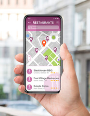 Female traveller using GPS navigation app to find good restaurants on smartphone screen on street,...